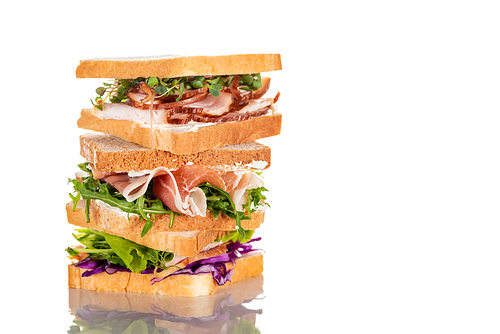 fresh sandwiches with arugula and meat on white surface