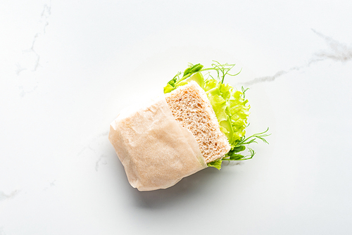 top view of vegan fresh green sandwich on marble white surface