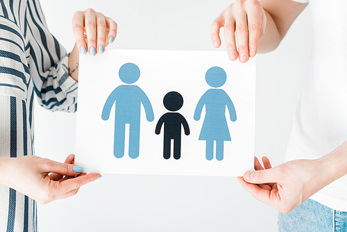 cropped view of man and woman holding paper with drawn family isolated on white, adoption concept