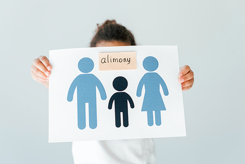 african american kid covering face while holding paper with drawn family and alimony lettering isolated on white