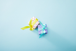 top view of dotted colorful gift boxes on blue background