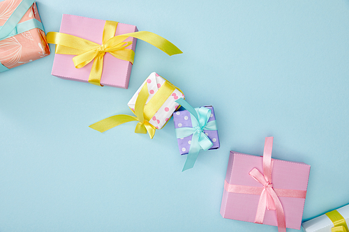 top view of festive colorful gift boxes on blue background