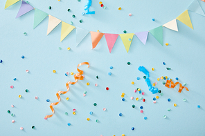 top view of colorful confetti on blue background