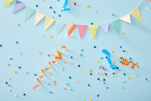 top view of colorful confetti on blue background