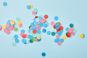 top view of colorful round confetti on blue background