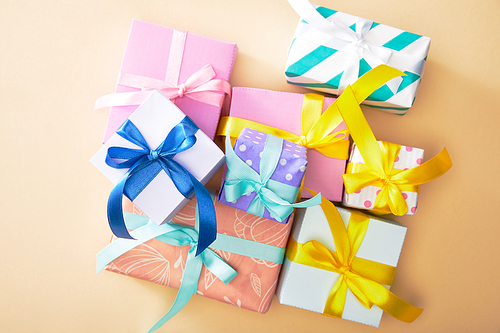 top view of festive colorful gift boxes on beige background