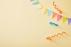 top view of festive colorful confetti on beige background