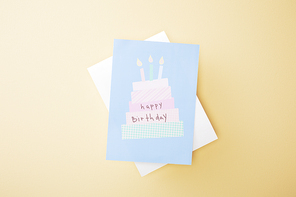 top view of festive happy birthday greeting card on beige background