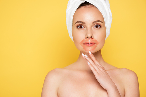 naked beautiful woman with towel on head, lip patch isolated on yellow