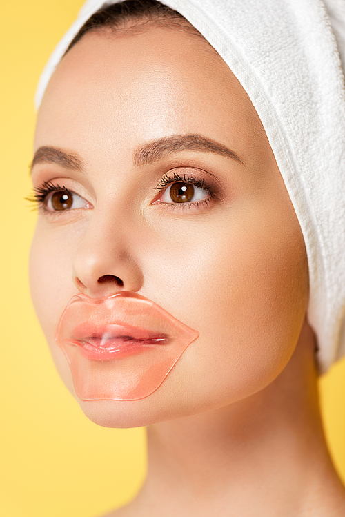 beautiful woman with towel on head, lip patch isolated on yellow