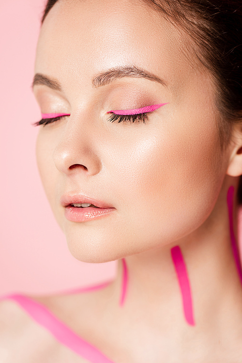 portrait of naked beautiful woman with pink lines on body and closed eyes isolated on pink