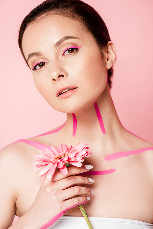 beautiful woman with pink lines on body and chrysanthemum isolated on pink