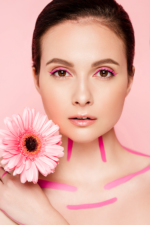 naked beautiful woman with pink lines on body and chrysanthemum isolated on pink