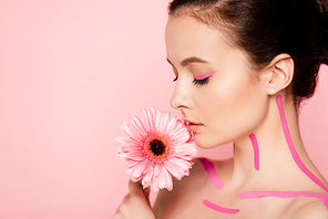 naked beautiful woman with pink lines on body and chrysanthemum isolated on pink