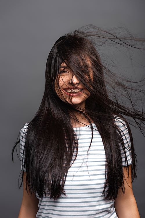 wind blowing through hair of brunette woman isolated on black | 유토이미지 ...