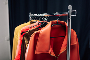 selective focus of hanger with stylish jackets in photo studio