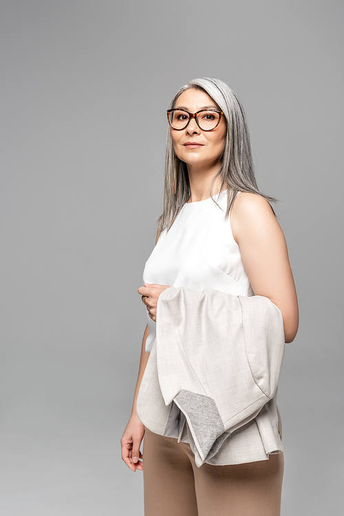 confident asian businesswoman in eyeglasses isolated on grey