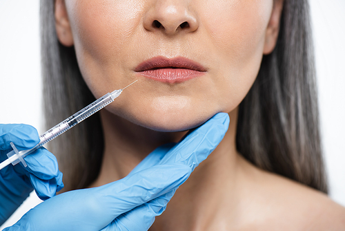 cropped view of naked adult woman and doctor in latex gloves holding syringe with beauty injection isolated on grey