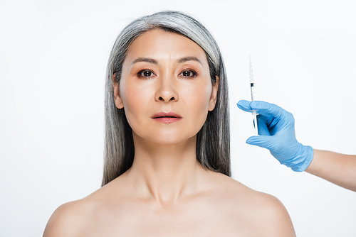 beautiful naked asian woman and doctor in latex gloves holding syringe with beauty injection isolated on grey