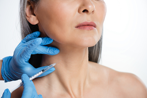 cropped view of naked woman and doctor in latex gloves holding syringe with beauty injection isolated on grey