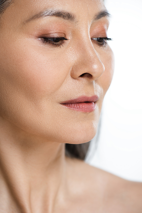 close up of adult asian naked woman with perfect skin and grey hair isolated on grey