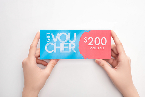 Top view of woman holding gift voucher with 200 values sign on white background