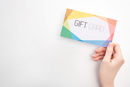 Top view of woman holding gift card on white background