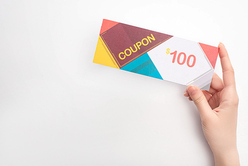 Cropped view of woman holding coupon with 100 dollars sign on white background