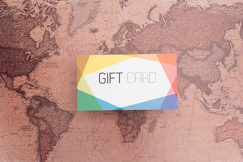 Top view of colorful gift card on map surface