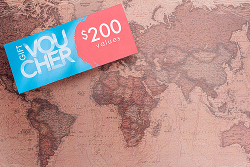 Top view of gift voucher with 200 values lettering on map surface