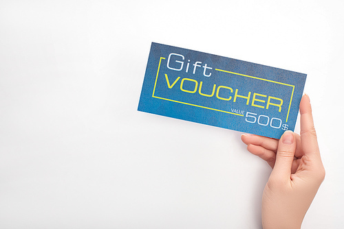 Top view of woman holding blue gift voucher with value and dollar sign on white background