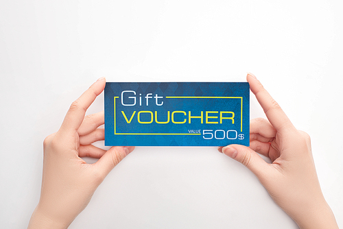 Top view of woman holding gift voucher with dollar sign on white background