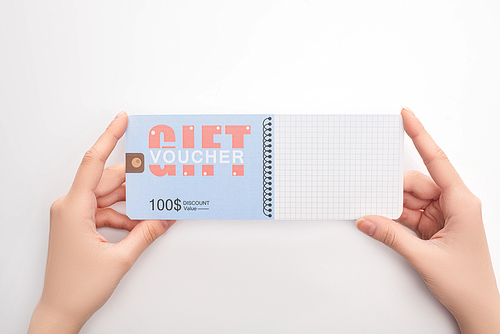 Top view of woman holding gift voucher with 100 dollars discount on white background