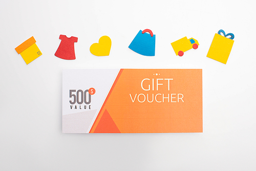 Top view of paper artwork with gift voucher on white background