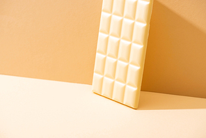 whole delicious white chocolate bar on beige background