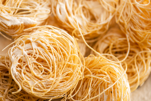 close up view of raw Italian Capellini with flour