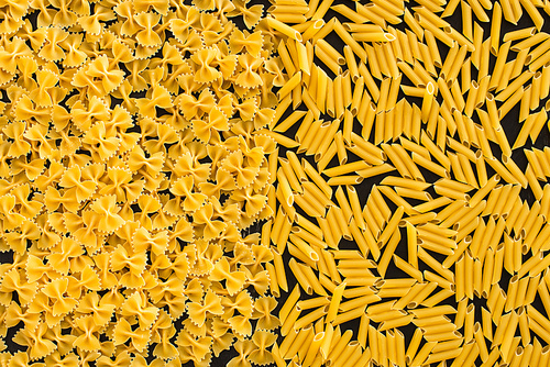 top view of raw penne and farfalle pasta