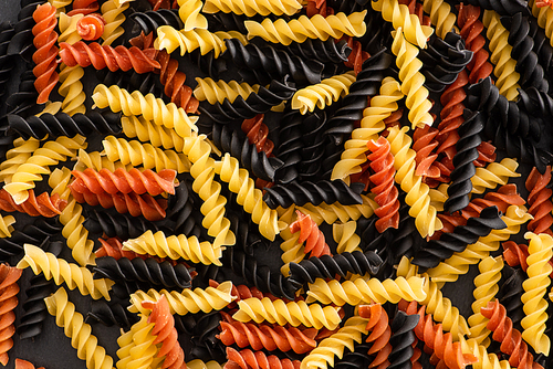 top view of raw colorful fusilli pasta