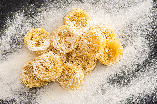 top view of raw Capellini pasta in flour
