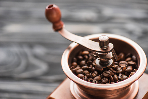 close up view of vintage coffee grinder with coffee beans