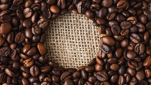 round frame of coffee beans on burlap