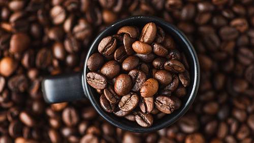 top view of fresh roasted coffee beans in cup