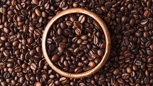 top view of coffee beans in wooden bowl