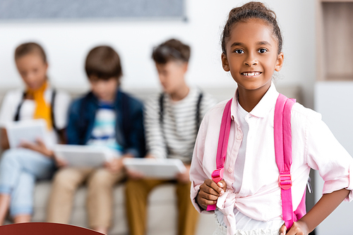 Selective focus of african american schoolgirl  in classroom