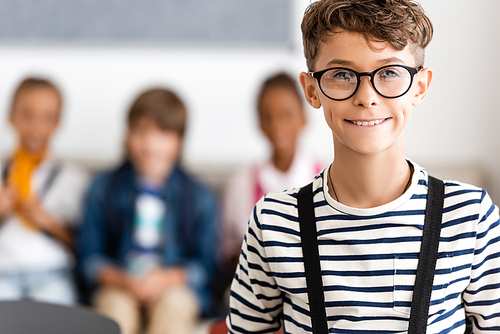 Selective focus of schoolboy in eyeglasses  in school