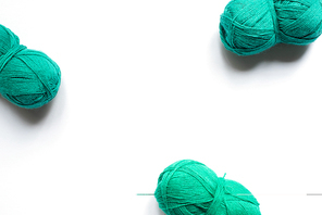 top view of green wool yarn on white background