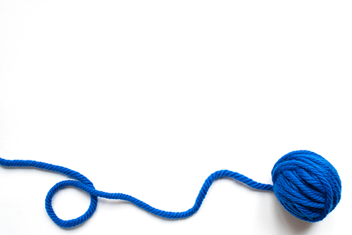 top view of blue wool yarn on white background