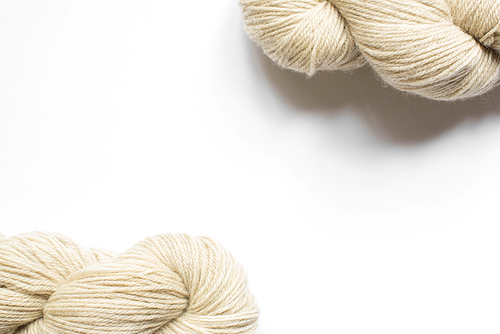 beige yarn on white background with copy space