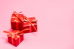 selective focus of red gift boxes on pink, black friday concept