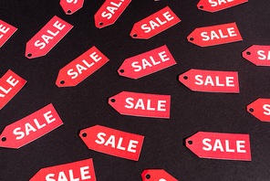 red labels with sale lettering on black background